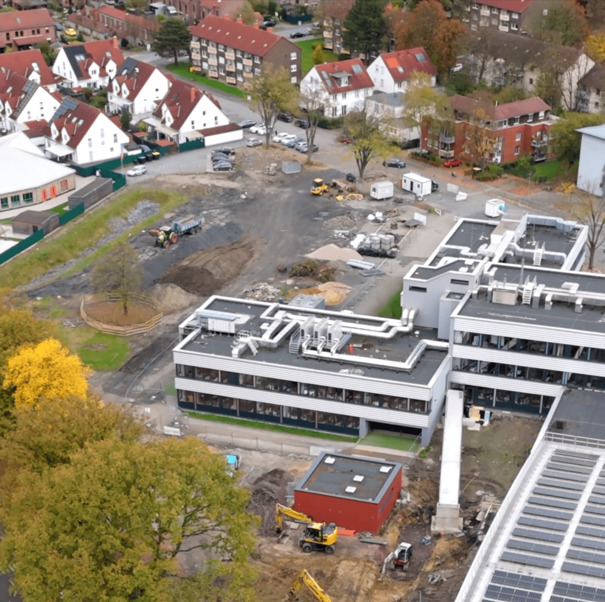 Luftaufnahme eines Gebäudekomplexes mit angelegten Grünflächen
